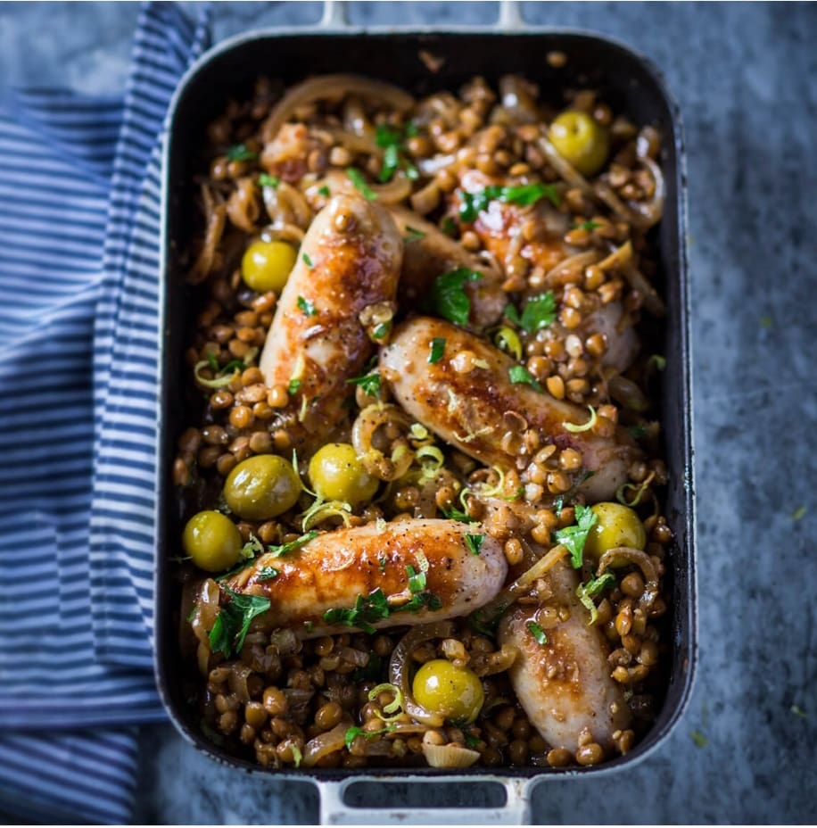 Sausages with braised lentils, lemon and green olives